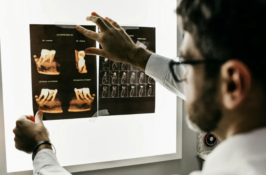 A dentist reviewing x-ray scans